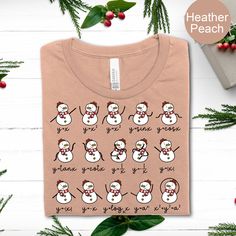 a t - shirt with snowmen on it and the words, you're going to