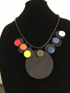 Multicultural, multicolored foam rubber necklace with wood beads and an adjustable 2 inch chain with lobster claw closure. 23 inches long with 14.5 drop (laying flat). Very light weight. 6 1 inch small pendant  with .75 inch wooden bead  and large 3 inch pendant with wooden bead. Light Weight Necklace, Bold Color, Small Pendant, Durham, Wooden Beads, Wood Beads, Lobster Claw, Bold Colors, Circles