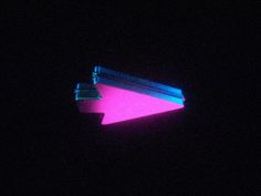 a pink and blue object in the dark