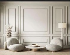 an empty room with two chairs and a coffee table in front of a white wall