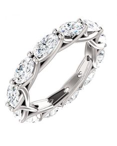 a white gold ring with oval cut diamonds on the sides and an intertwined band