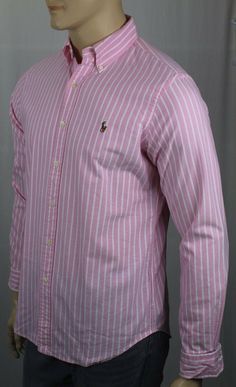 Ralph Lauren Pink Striped Classic Oxford Shirt Multi Colored Pony NWT -Ralph Lauren- -New with Tags- -Long sleeved button-down shirt, cut for a Classic fit. -Tailored from 100% Cotton in Pink Cream Striped Pattern -Button-down collar, split back yoke, shirt tail hem. -Embroidered Multi Colored Pony on chest -Machine washable.   ~Measurements~     Small Medium Large X-Large XX-Large ARMPIT TO ARMPIT 22" (55.9 cm) 23.5”(59.7cm) 25” (63.5 cm) 26” (66 cm) 28.5”(72.4cm) SHOULDER TO FRONT HEM 29” (73. Ralph Lauren Striped Shirt For Spring, Pink Slim Fit Button-up Tops, Pink Cotton Shirt With Placket, Long Sleeve Shirt With Placket For Spring, Pink Long Sleeve Shirt With Buttons, Ralph Lauren Striped Collared Tops, Ralph Lauren Fitted Long Sleeve Tops, Ralph Lauren Spring Workwear Shirt, Spring Striped Ralph Lauren Top