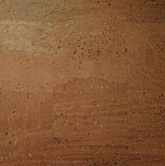 an orange and black fire hydrant sitting on top of a dirt field