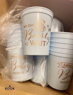 we can baby wait cups are stacked on top of each other in a cardboard box