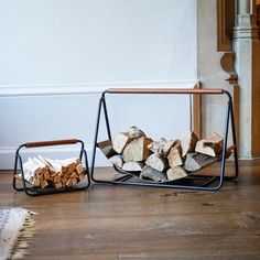 a stack of firewood sitting on top of a wooden floor next to a pile of logs