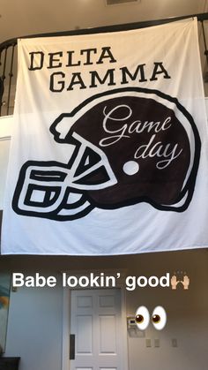 a banner that says delta garma game day with a football helmet on it and the words babe lookin'good