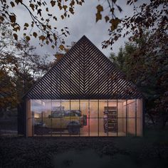 a car is parked in front of a building with glass walls on the outside and inside