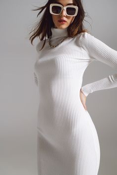 Emanate sophistication and comfort with our Midi Bodycon Knitted Dress with Turtle Neck in White. Lovingly crafted from a rich blend of 40% viscose, 30% polyester, and 30% nylon, this dress embodies softness and elasticity in its ribbed knit design. The turtleneck neckline, coupled with its long sleeves, ensures that you remain cozy, while also making a stylish statement on cooler days. This dress's bodycon fit is tailored to accentuate the body's natural curves, making it a timeless piece for a White Dress Turtleneck, Classic Mini Dress For Winter, Classic Mini Length Winter Dress, Classic Mini Winter Dresses, Elegant Maxi Sweater Dress, Long Bodycon Sweater Dress, Elegant Stretch Sweater Dress In Maxi Length, Classic Knee-length Mini Dress For Winter, Elegant Winter White Dress For Fall