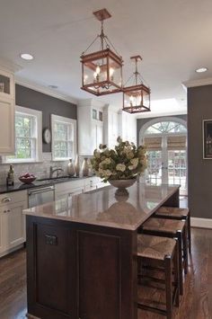 a large kitchen with an island in the middle