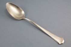 a silver spoon sitting on top of a table