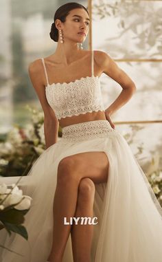 a woman sitting on top of a chair wearing a white dress