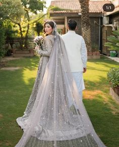 the bride and groom are standing outside together