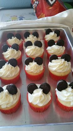 cupcakes with white frosting and mickey mouse decorations