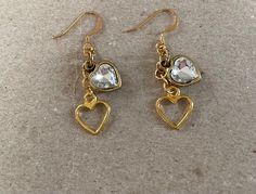 These earrings have been made using gold tone, crystal heart charms, recovered from vintage jewellery, open heart charms, gold plated jump rings and gold plated, quality ear wires. Earring Drop Length: 3cm Gold Heart-shaped Crystal Earrings For Pierced Ears, Gold Heart-shaped Crystal Earrings, Nickel-free Double Heart Gold Earrings, Nickel-free Gold Double Heart Earrings, Gold Double Heart Nickel-free Earrings, Gold Crystal Earrings For Valentine's Day, Vintage Gold Heart Earrings Nickel Free, Gold Nickel-free Dangle Heart Earrings, Vintage Gold Nickel-free Heart Earrings