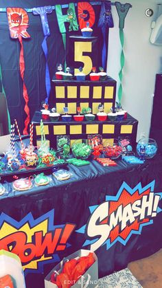 a table topped with lots of cupcakes and candy