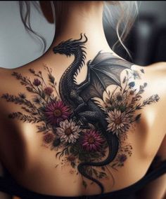 a woman with a dragon tattoo on her back