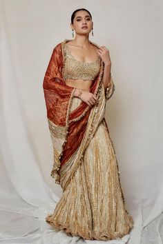 Metallic rose gold palazzo saree with textured pattern. Paired with mirror embroidered bustier and stripe woven dupatta.
Components: 3
Type Of Work: Stripe
Neckline: Round
Sleeve Type: Cap sleeves
Fabric: Palazzo and Dupatta: Metallic Tissue, Blouse: Organza, Lining: Artificial Crepe
Color: Pink,Gold
Other Details: 
Back tassel tie-up
Length: 
Blouse: 14 inches
Palazzo: 42 inches
Approx. product weight: 3 kgs
Occasion: Sangeet - Aza Fashions Palazzo Saree, Blouse Organza, Embroidered Bustier, Dhoti Saree, Draped Saree, Drape Saree, Blouse For Women, Pink Saree, Saree With Blouse