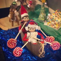 two elfs in a boat with candy canes