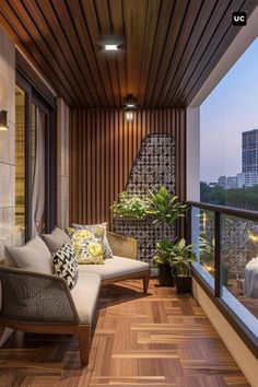 a balcony with wooden floors and white furniture on top of it, overlooking the city