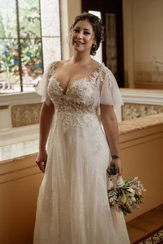 a woman in a wedding dress holding a bouquet