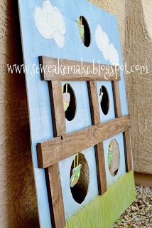 a wooden structure with holes in it on the side of a building that is painted blue and green