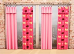 two pink curtains with donuts and stars on them in front of a brick wall