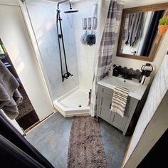 a bathroom with a walk in shower next to a sink