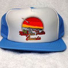 - Niagara Falls Canada - Vintage Truckers Hat - Has A Picture Of The Falls And Sunset And A Seagull - Hampstead House, Inc Brand - Blue Bill And White Front With Blue Nylon Mesh Back - Snapback Adjustment - Brand New Retro Summer Trucker Hat With Wide Brim, Retro Wide Brim Trucker Hat For Summer, Retro White Trucker Hat For Summer, Retro White Hats For Summer, Retro Blue Hats For Outdoor, White Retro Hats For Vacation, White Retro Hat For Vacation, Retro White Trucker Hat For Beach, Retro White Baseball Cap For Summer