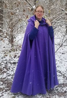 "This long purple cloak is a full circle of soft warm fleece, giving it wonderful movement and flow. Made to order, this cloak can be up to 58\" long. It has a full hood and closes with a matching cloth frog. This cloak is a great costume piece for your local renaissance faire or festival and is comfortable for cold days. Or wear it every day to keep warm and dry in medieval style! To measure the proper length for your cloak, measure from your shoulder to the length down your leg you want the cl Hooded Outerwear For Fantasy Events In Winter, Cape With Arm Holes, Purple Winter Costume Outerwear, Fantasy Hooded Winter Outerwear, Hooded Cape For Fantasy Events In Winter, Hooded Winter Cape For Fantasy Events, Full Circle Hooded Cloak Pattern, Winter Fantasy Cape Outerwear, Cloak With Arm Holes