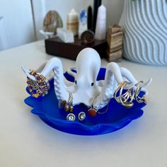 an octopus ring holder on a blue plate