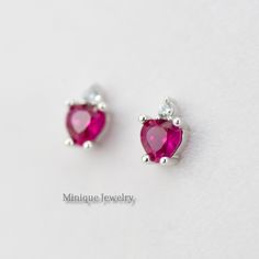 The Pinkish Red color is vibrant and sweeps across the stone.  The stone is a brilliant-cut style of Ruby Red, showing off the depths of red that are completely mesmerizing, and a tiny CZ on top of the heart-shaped gems. 🎀 Material: 0.925 Sterling Silver 🎀 Finishing: High Polish, Rhodium plated (Anti-Tarnish) 🎀 Width: 5 mm 🎀Height: 6 mm 🎀 Shape: Heart 🎀 Closure: Push Back 🎀 Sold as a PAIR ✈️READY TO SHIP the next day! 🎀 Please note that pictures are magnified to show the details. Please Pink Heart-shaped Gemstone Earrings, Pink Heart Gemstone Earrings, Red Heart-shaped Cubic Zirconia Earrings, Valentine's Day Birthstone Earrings In Cubic Zirconia, Valentine's Day Birthstone Earrings With Cubic Zirconia, Valentine's Day Heart Gemstone Earrings, Red Ruby Birthstone Earrings, Red Heart Pendant Earrings For Anniversary, Heart-shaped Gemstone Earrings As Gift