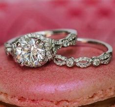 two engagement rings sitting on top of a donut