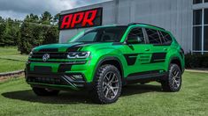 a green volkswagen atlas pickup truck parked in front of a building with the word apr on it