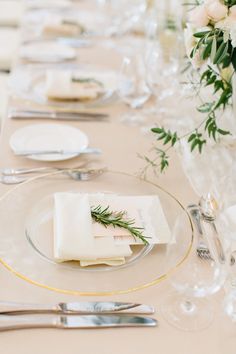 the table is set with place settings and silverware