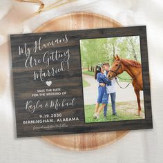 a wooden photo frame with an image of two people and a horse