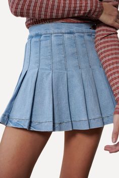 Denim mini skirt featuring pleats all round, one button on the side of the waist, and an invisible side zip closure. Crafted with slightly stretchy cotton fabric. -High waistline.-Side button and zip closure.-Pleated front and back.-99% Cotton 1% Spandex. Size Guide -The model is wearing a size Small.-The model is 5'8" tall.-Length of size Small is 14"-WAIST S 24-26" M 26-28" L 28-30" Shipping ﻿-Ships from the US within 5-7 days. Fitted Tennis Skirt With Pockets For Spring, Trendy Fitted Medium Wash Skort, Fitted Short Length Cotton Denim Skirt, Trendy Stretch Cotton Tennis Skirt, High Waist Medium Wash Cotton Skort, High Waist Cotton Denim Pleated Skirt, Fitted Denim Mini Skort, High Waist Pleated Cotton Denim Skirt, High Waist Pleated Denim Skirt In Cotton