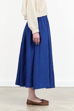 The Wide Skirt is created from soft linen, featuring a flowy A-line silhouette that adds to its chic midi length. This elegant and comfortable piece offers a graceful fit, that makes it perfect for those seeking a harmonious blend of playful charm and sophisticated style. Chic Linen Voluminous Skirt, Chic Voluminous Linen Skirt, Chic Blue Skirt With Relaxed Fit, Flowy Full Linen Skirt, Chic Linen Full Skirt Bottoms, Blue Gathered Midi-length Maxi Skirt, Chic Full Skirt Bottoms In Linen, Blue Midi Length Gathered Maxi Skirt, Blue Relaxed Fit Midi Skirt