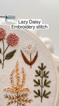 a close up of a embroidery pattern on a white surface with text that reads lazy daisy embroidery stitch