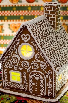 a gingerbread house is decorated with icing