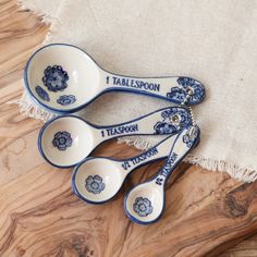 three blue and white spoons sitting on top of a table