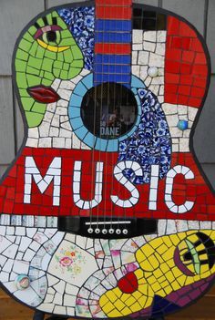 a colorful guitar with the words music painted on it