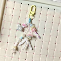 there is a keychain made out of beads and other things hanging on the wall