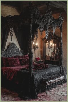 an ornate bed with red and black bedspread, chandelier and mirror