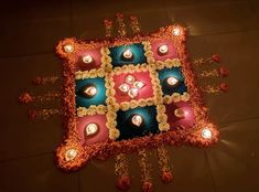 a decorative cushion with lit candles on it is shown in the middle of the floor