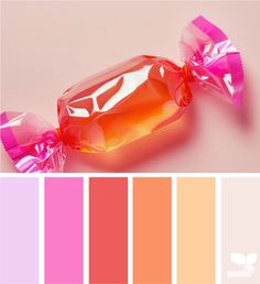 a candy bar wrapped in pink and orange wrapper next to color swatches on a white background