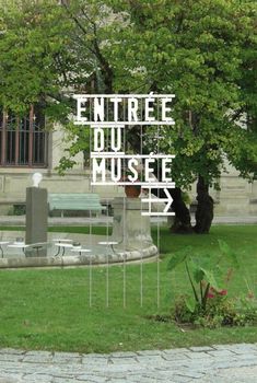 the words entre du museum are displayed in front of a park with benches and trees