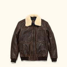 A leather jacket as rugged and iconic as the battle-tested captains of the sky. Where classic aviator style meets first-class quality and design. Crafted with 100% genuine lambskin leather, our brown leather bomber jacket features a zip closure, ribbed cuffs and waist, and a detachable sherpa collar to provide extra warmth and comfort for brisk nights on the town or chasing the horizon. On the outside, right away you’ll notice the buttery soft lambskin leather. From day one, it has that vintage, Aviator Leather Jacket, Heavy Clothing, Belt Top, Aviator Style, Leather Trench Coat, Suits Coats, Vintage Brown, Lambskin Leather, The Sky