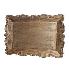 an old wooden tray with ornate carvings on the edges and sides, isolated against a white background