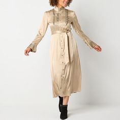 This Ryegrass women's midi dress has a beautiful slinky silhouette you'll love wearing to parties or special occasions. Made from satin, this long midi shirt dress has a waist tie to define the figure, a yoke and long sleeves with pleated trims for feminine flair. Wear it with pumps or ankle boots to complete the look. Closure Type: Tie, ButtonNeckline: Mock NeckSleeve Length: Long SleeveSleeve Style: Puffed SleeveApparel Length: 52 InchesDress Length: Midi LengthFiber Content: 100% PolyesterFab Women's A Line Dresses, Long Midi, A Line Dresses, Color Champagne, Large Dress, Medium Dress, Dress Yellow, Midi Shirt Dress, Long Sleeve Midi