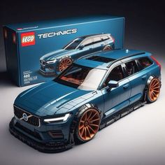 a blue car with orange rims is in front of a box that says lego technics